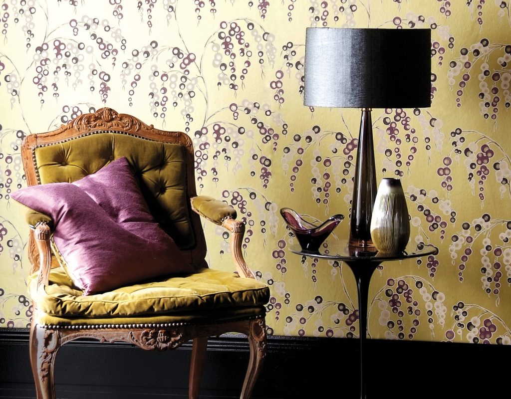 yellow vintage wallpaper with vintage chair and side table
