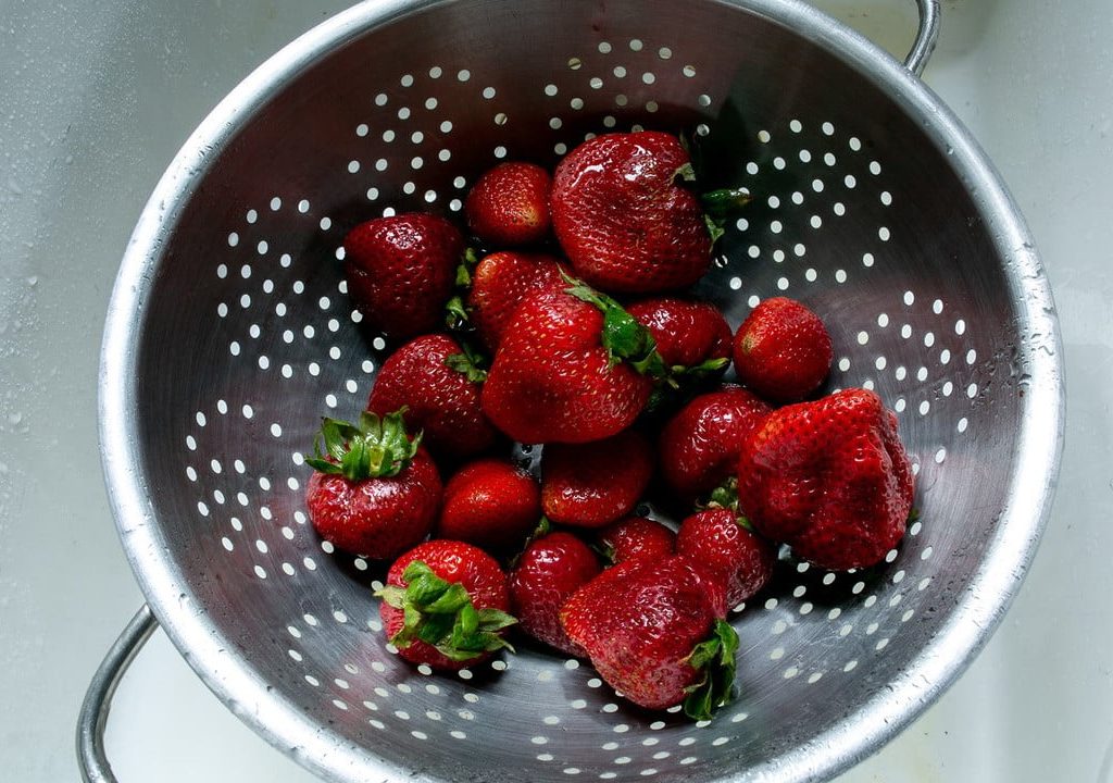 Strawberries in a metal strainer