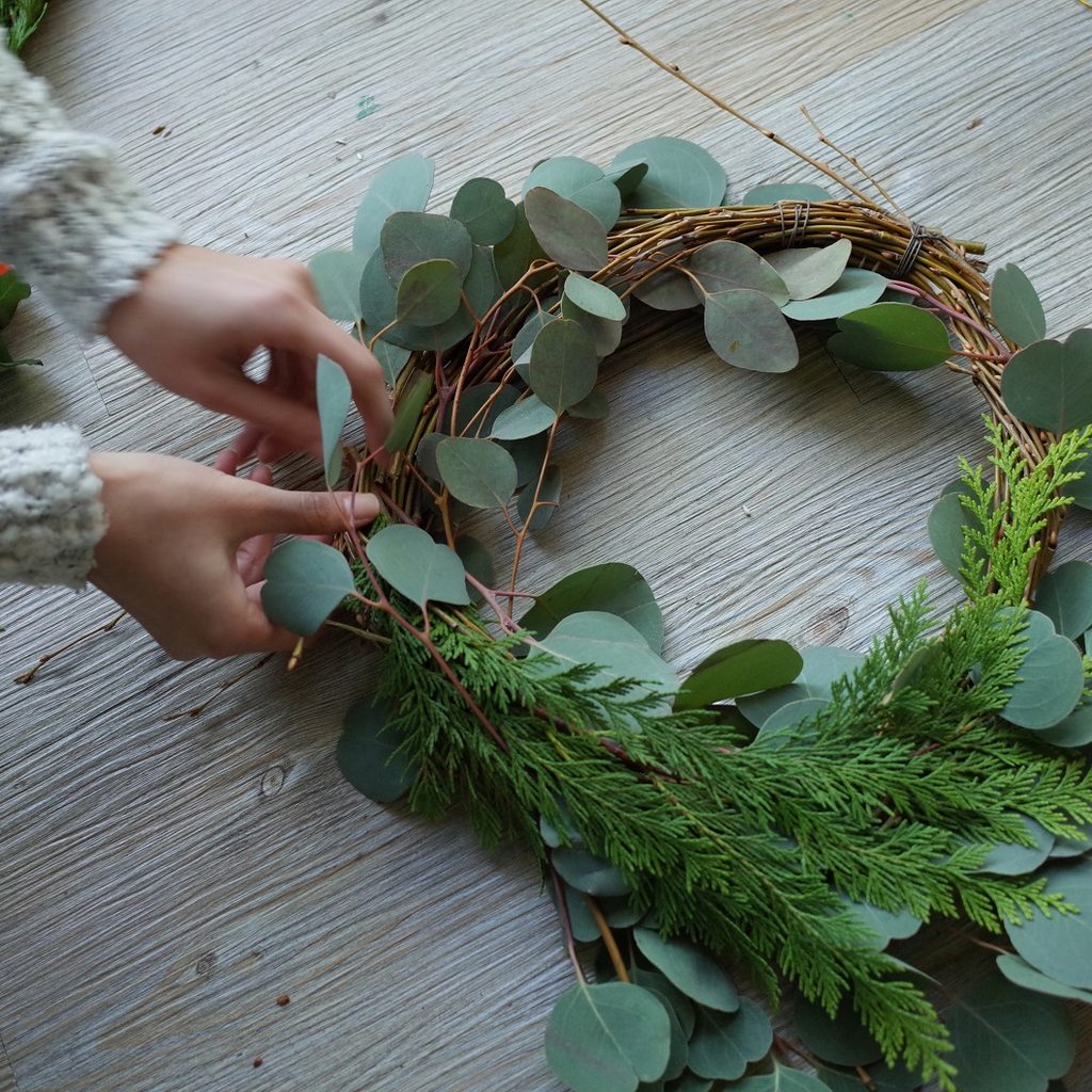 Person hand making a wreath
