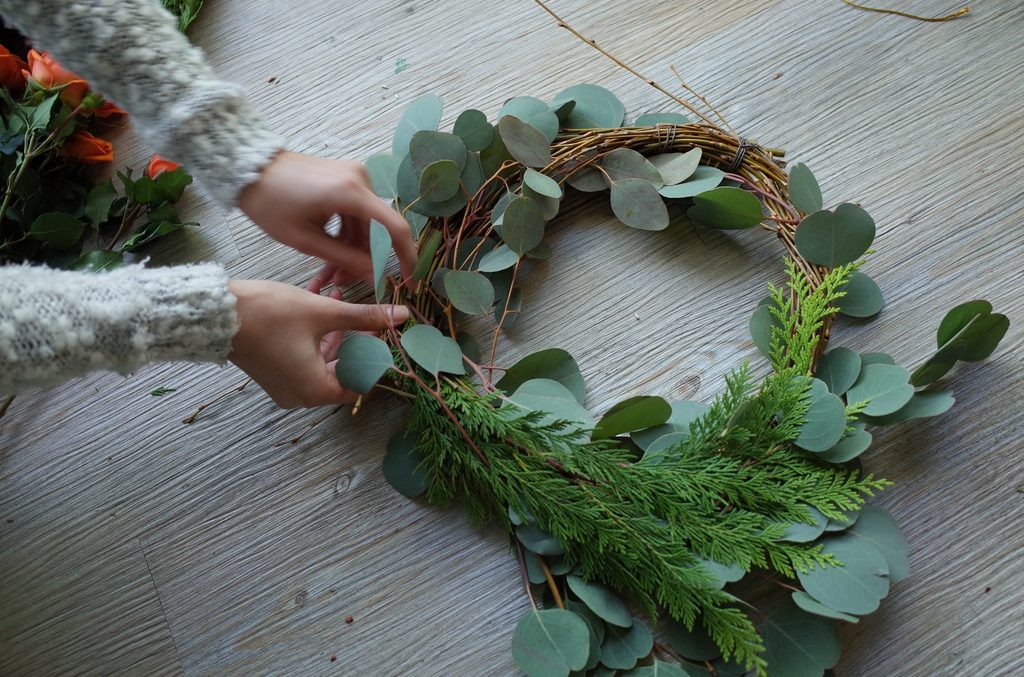 Person hand making a wreath