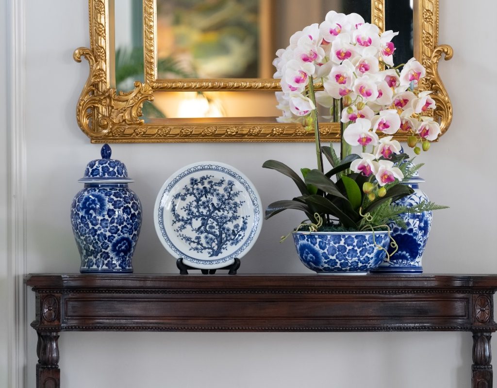 Blue and white porcelain plate china decor on entryway table with flowers