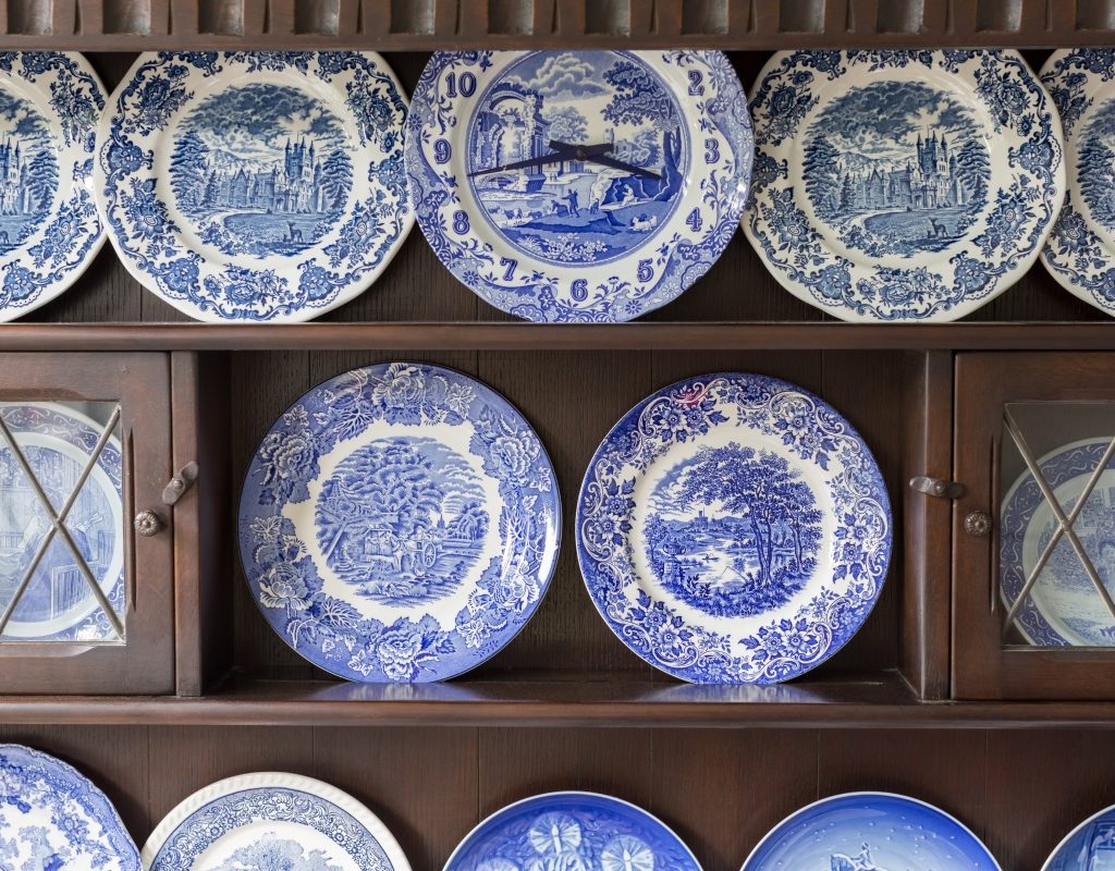 China cabinet with blue and white ceramic plates on display