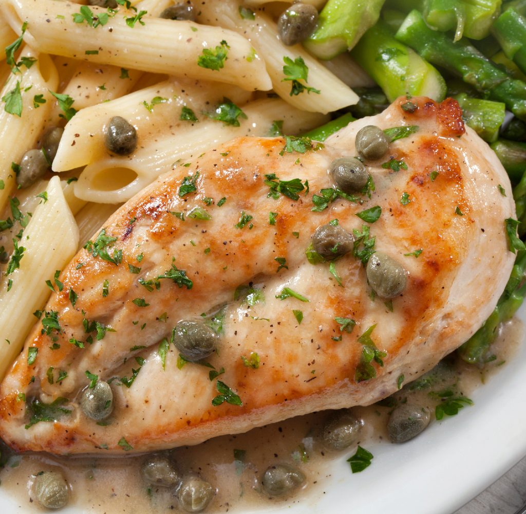 Close up of Chicken Piccata with pasta.