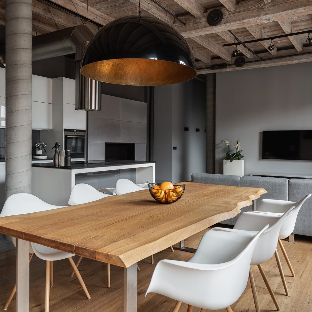contemporary industrial loft with black ceiling and large pendant light