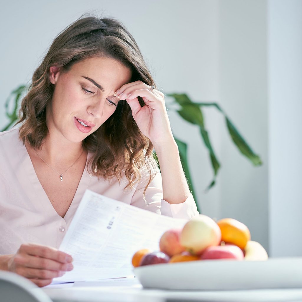Financially anxious woman looking at paperwork