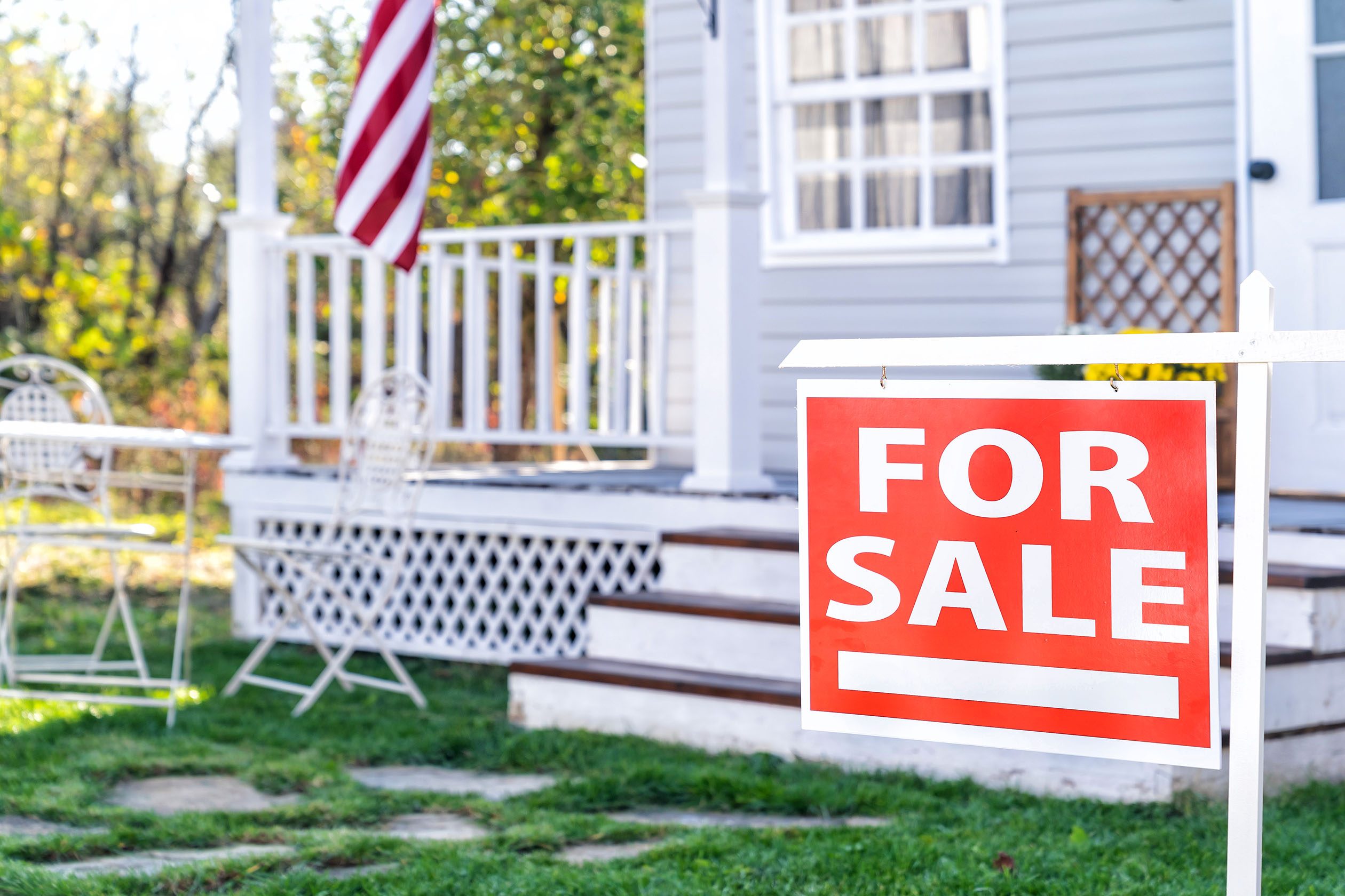 House with porch and a for sale sign
