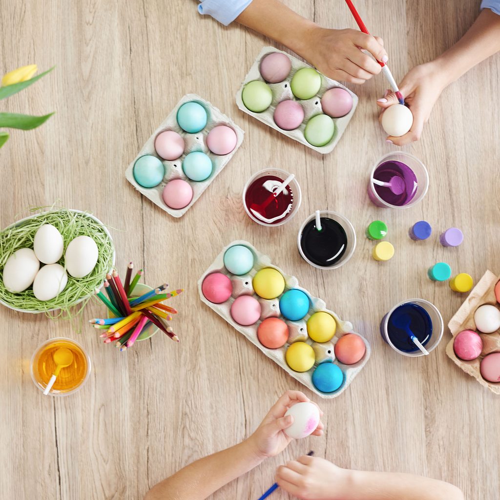 Mother and daughter painting Easter eggs