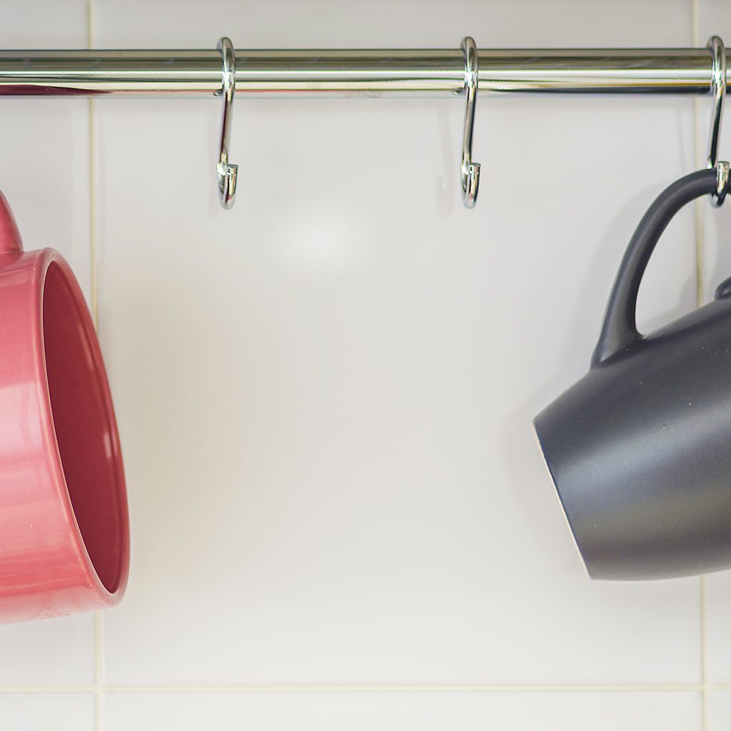 Two mugs hanging on a rack