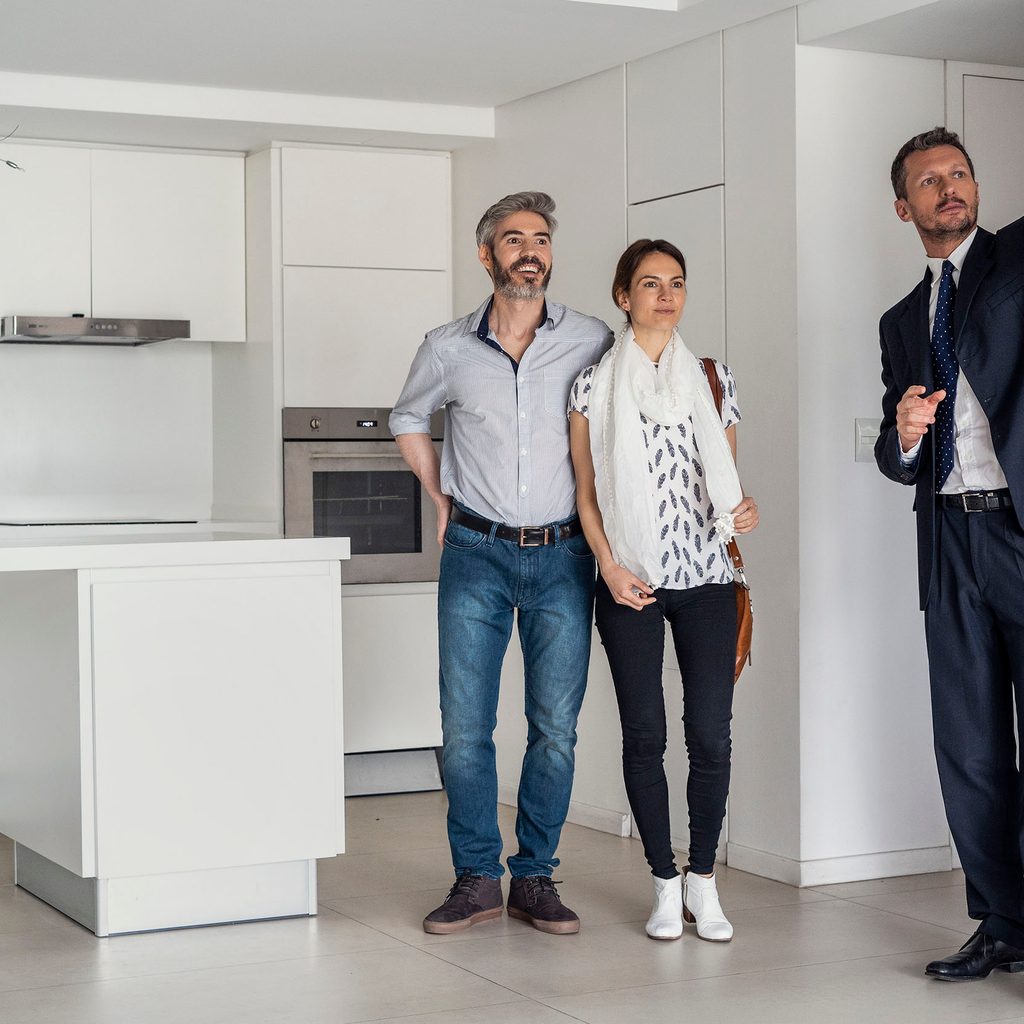 Realtor showing a couple a home