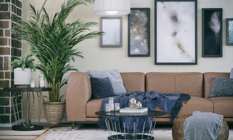 White living room with brown couch and blue accents.