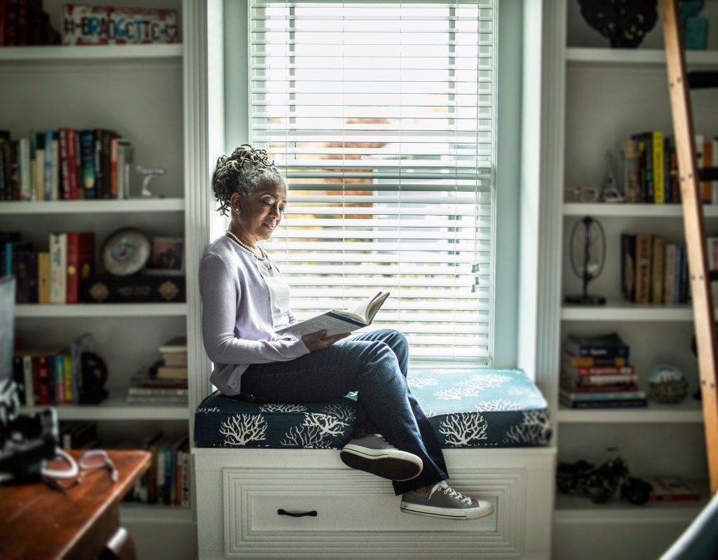 Woman reading in personal home library