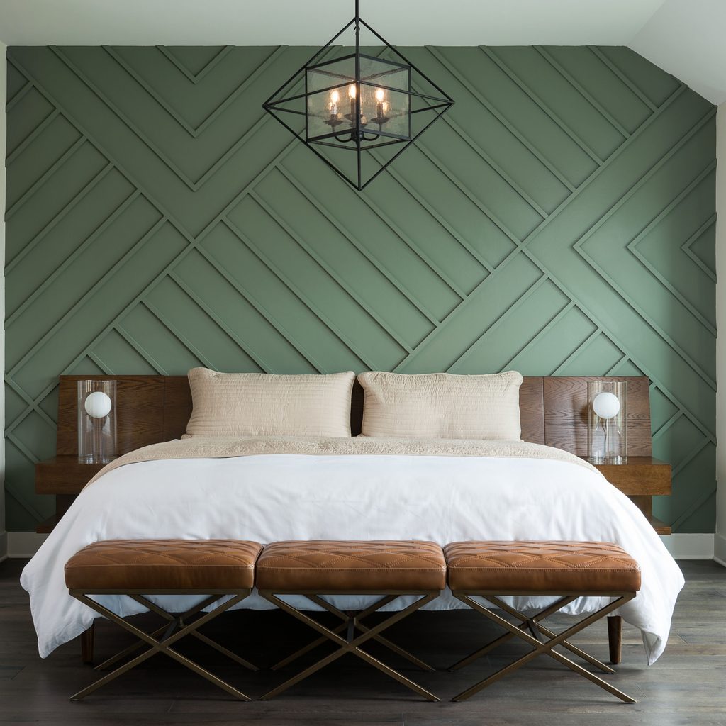 Bedroom with green wood panel accent wall