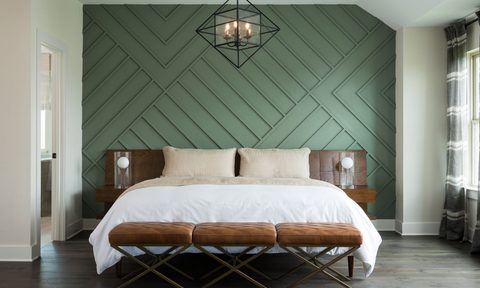 Bedroom with green wood panel accent wall