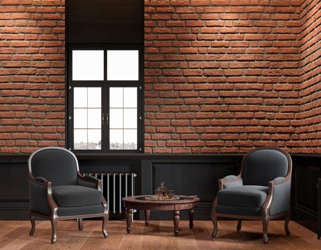 exposed red brick wall with dark color paneling and chairs