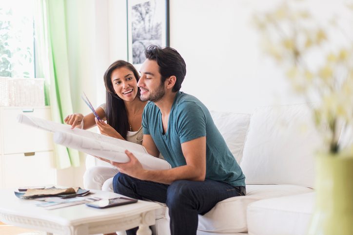 Couple sitting on sofa in living room