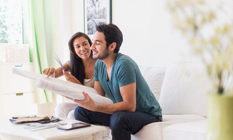 Couple sitting on sofa in living room