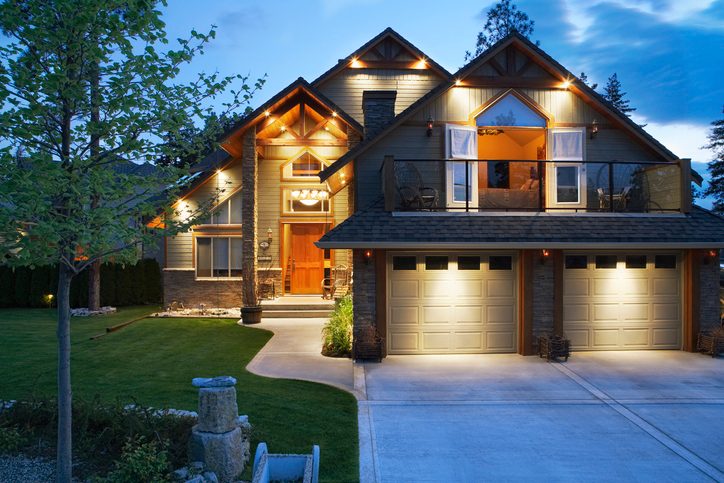 gray house exterior at dusk with night lighting