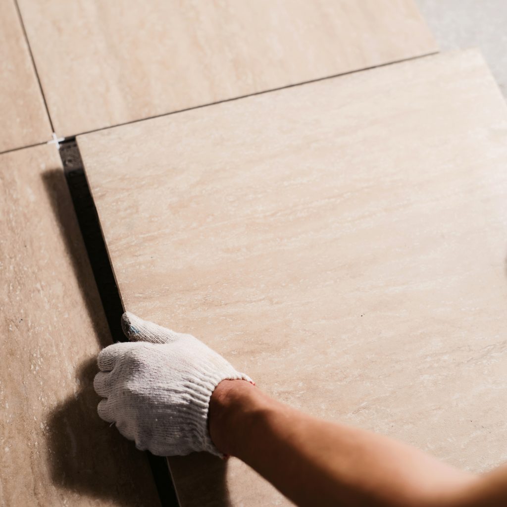 man laying flooring