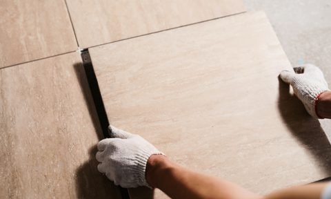 man laying flooring