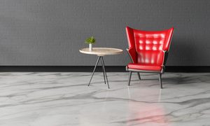 marble flooring in grey room with red chair and side table