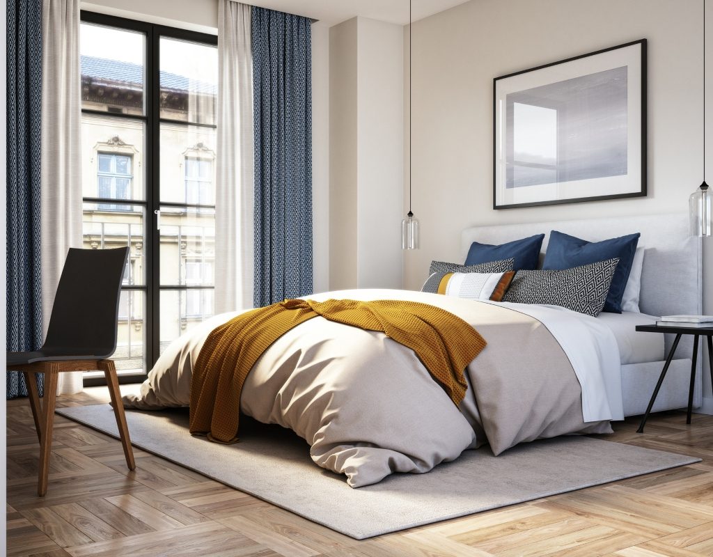 Modern bedroom with tall curtains and colorful blanket