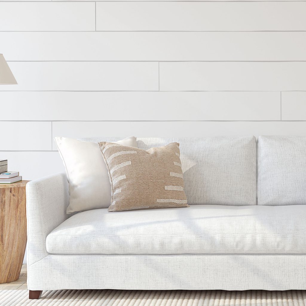 Modern farmhouse style couch with shiplap wall
