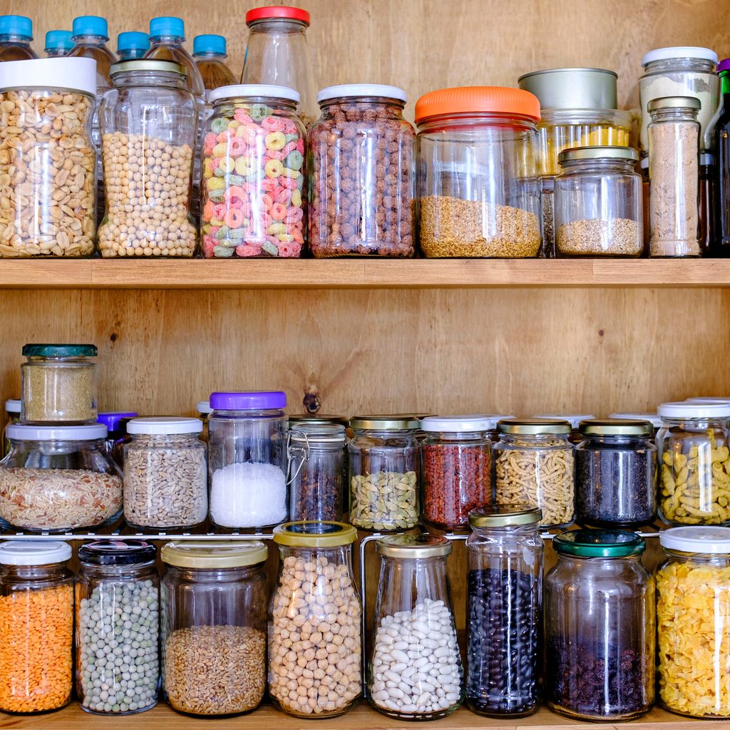 Organized kitchen pantry with food in clear containers