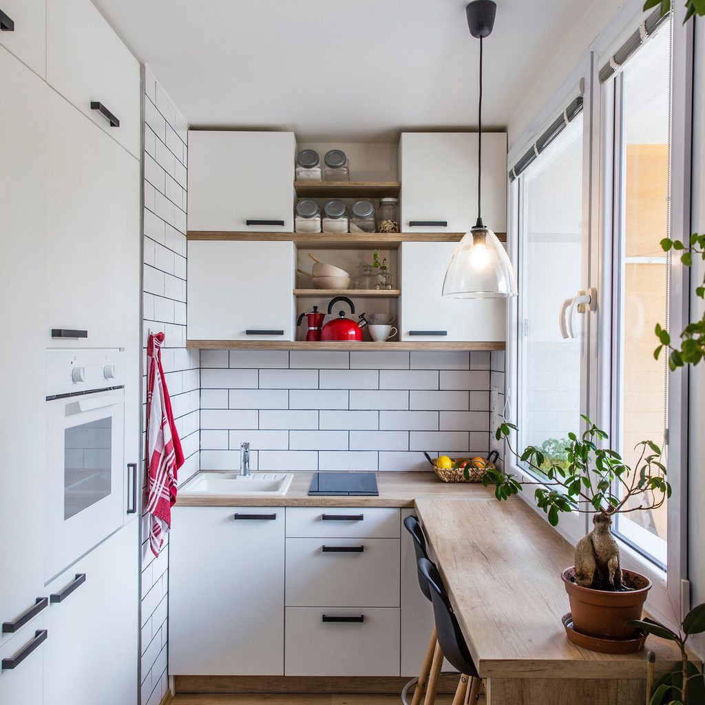 Small white kitchen with large windows