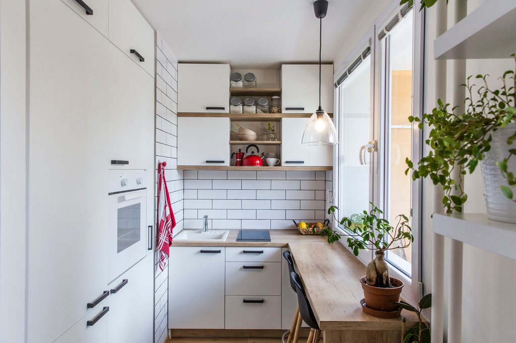 Small white kitchen with large windows