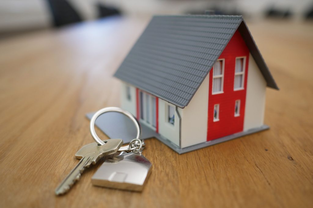 Tiny house with keys to represent buying a home