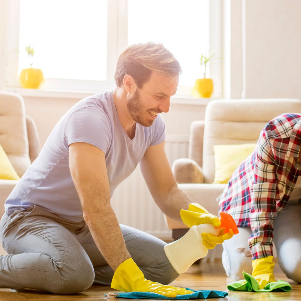 Young couple cleaning the floor together