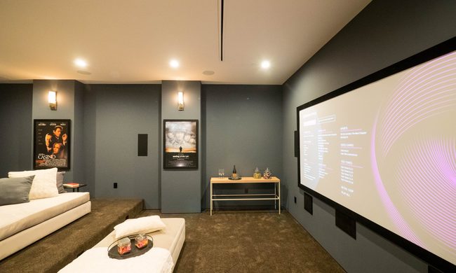 Media room basement with dark gray walls