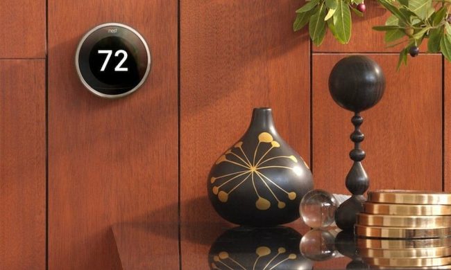 Nest Thermostat on wall with wood paneling