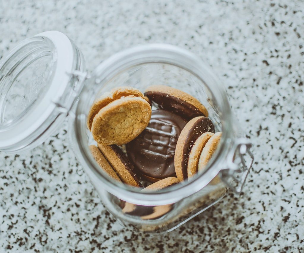 chocolate peanut butter cookies in a clear cookie jar