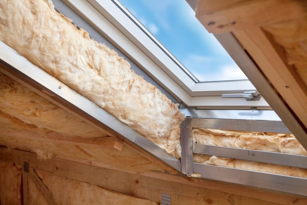 Attic skylight window with insulation surrounding it