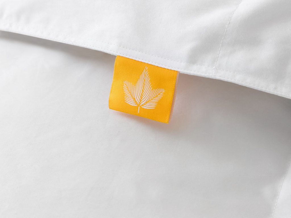 Canadian Down duvet logo close up with yellow.