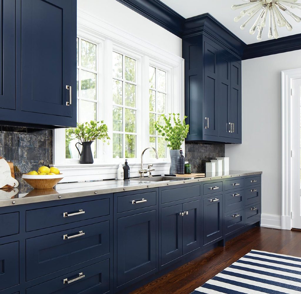 Kitchen with navy blue cabinets and brass hardware