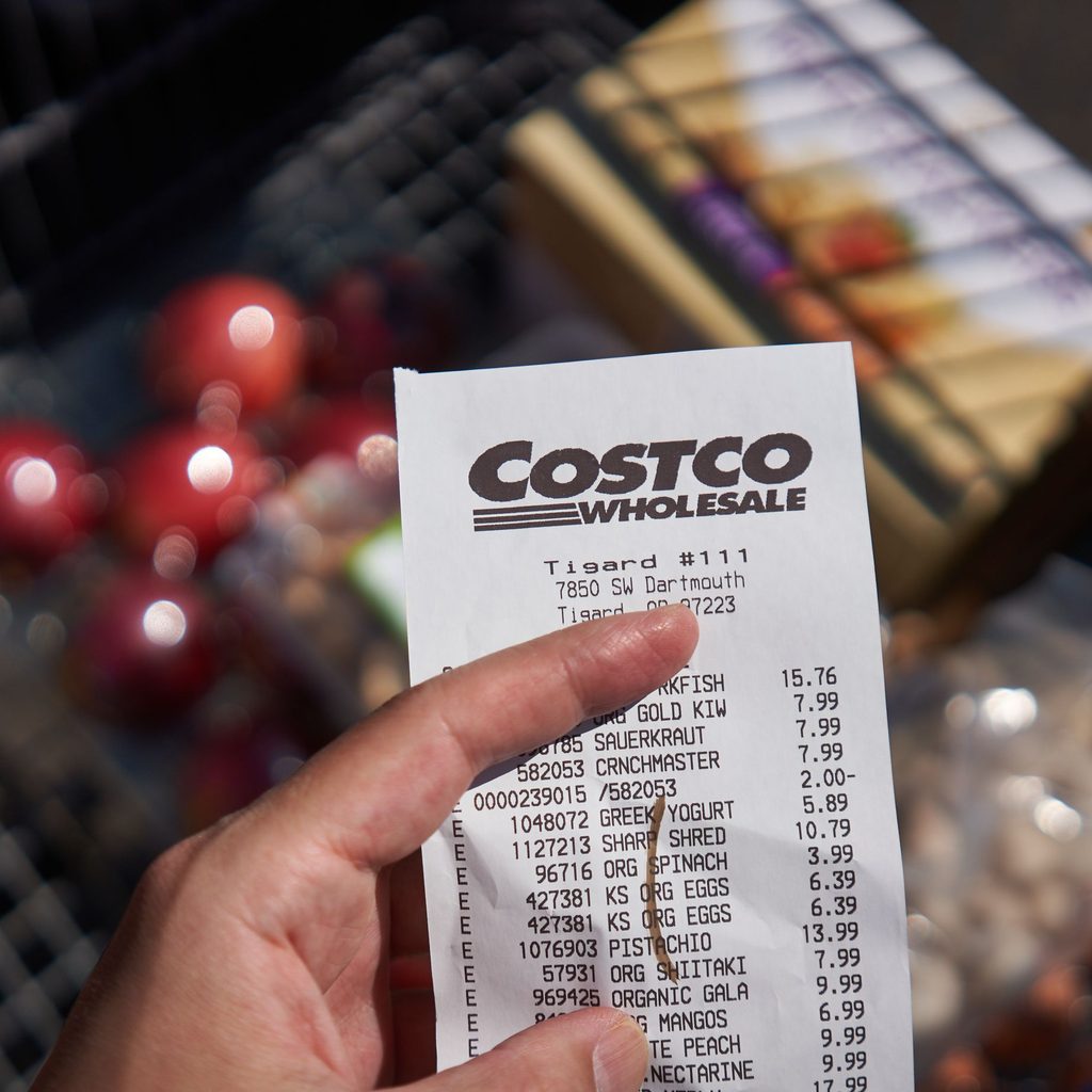 person holding costco receipt