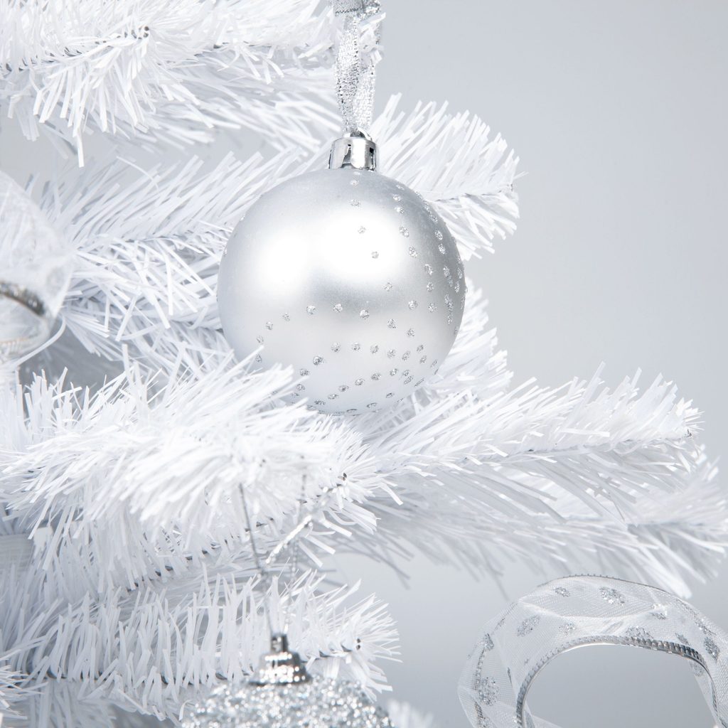 Silver ball ornament on a white Christmas tree