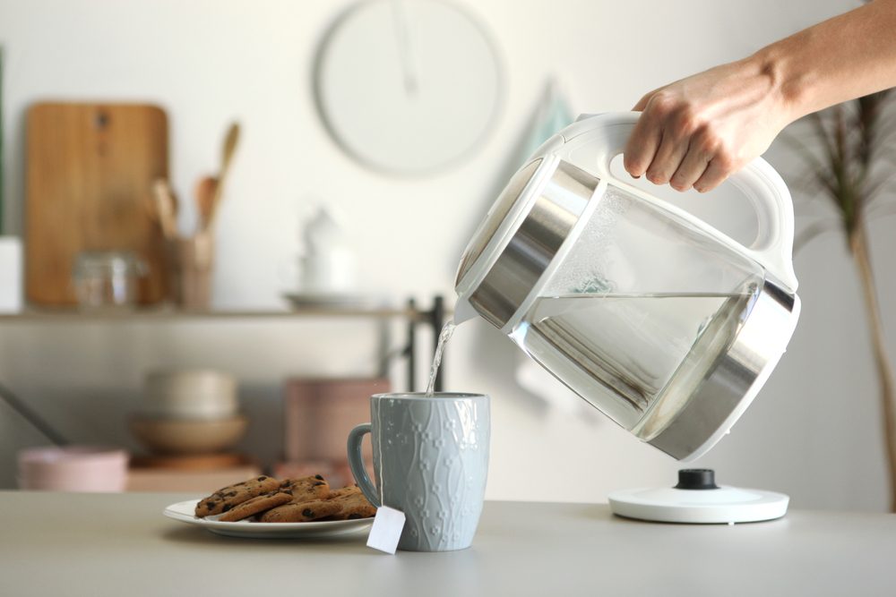 Pouring water from an electric tea kettle