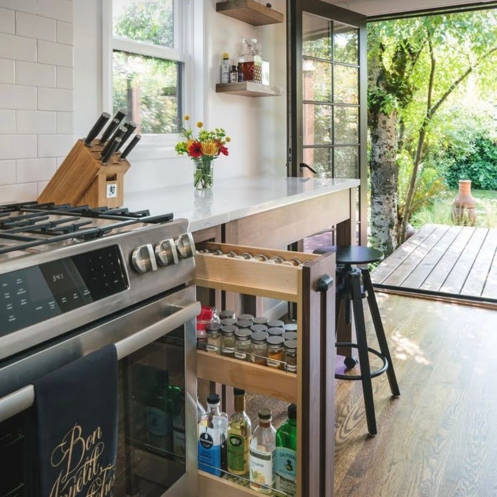 Custom pull-out spice rack in kitchen