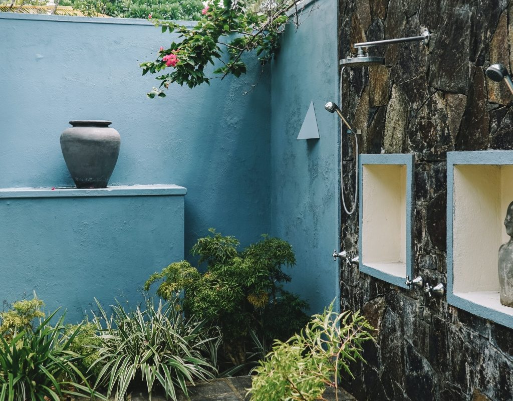 Blue outdoor shower with tile and statues