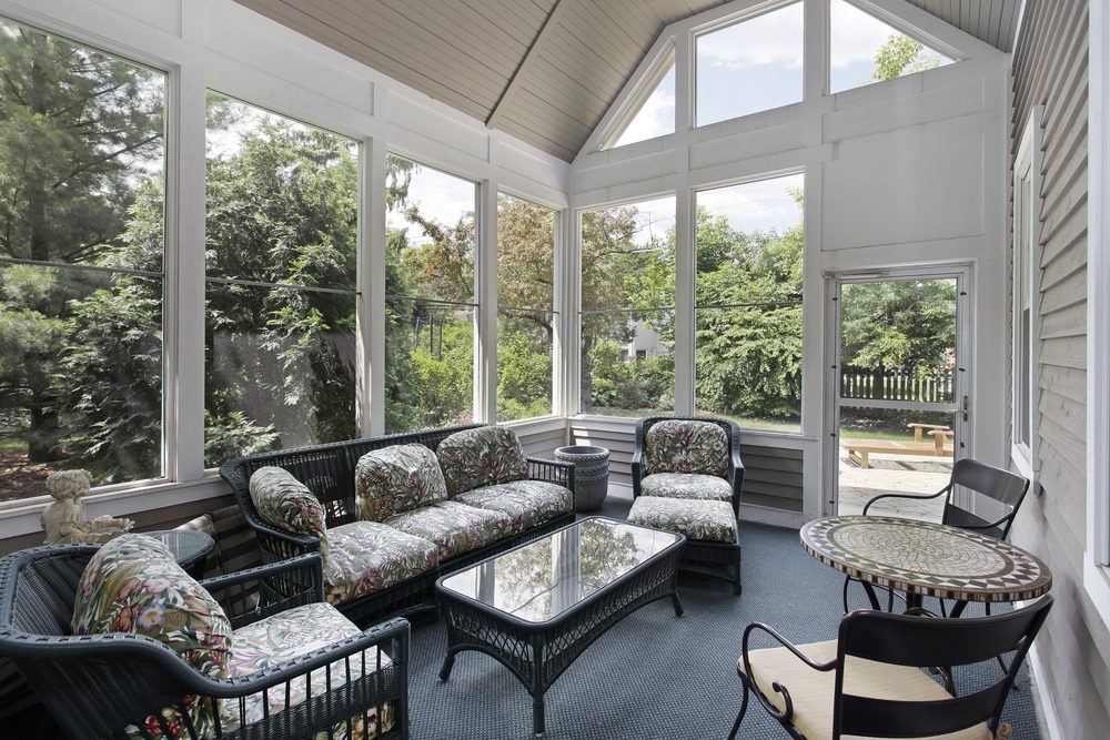 Screened-in porch with wicker furniture