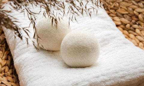 Wool dryer balls on a white cloth surface
