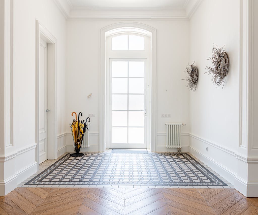 bright foyer with large window and white walls