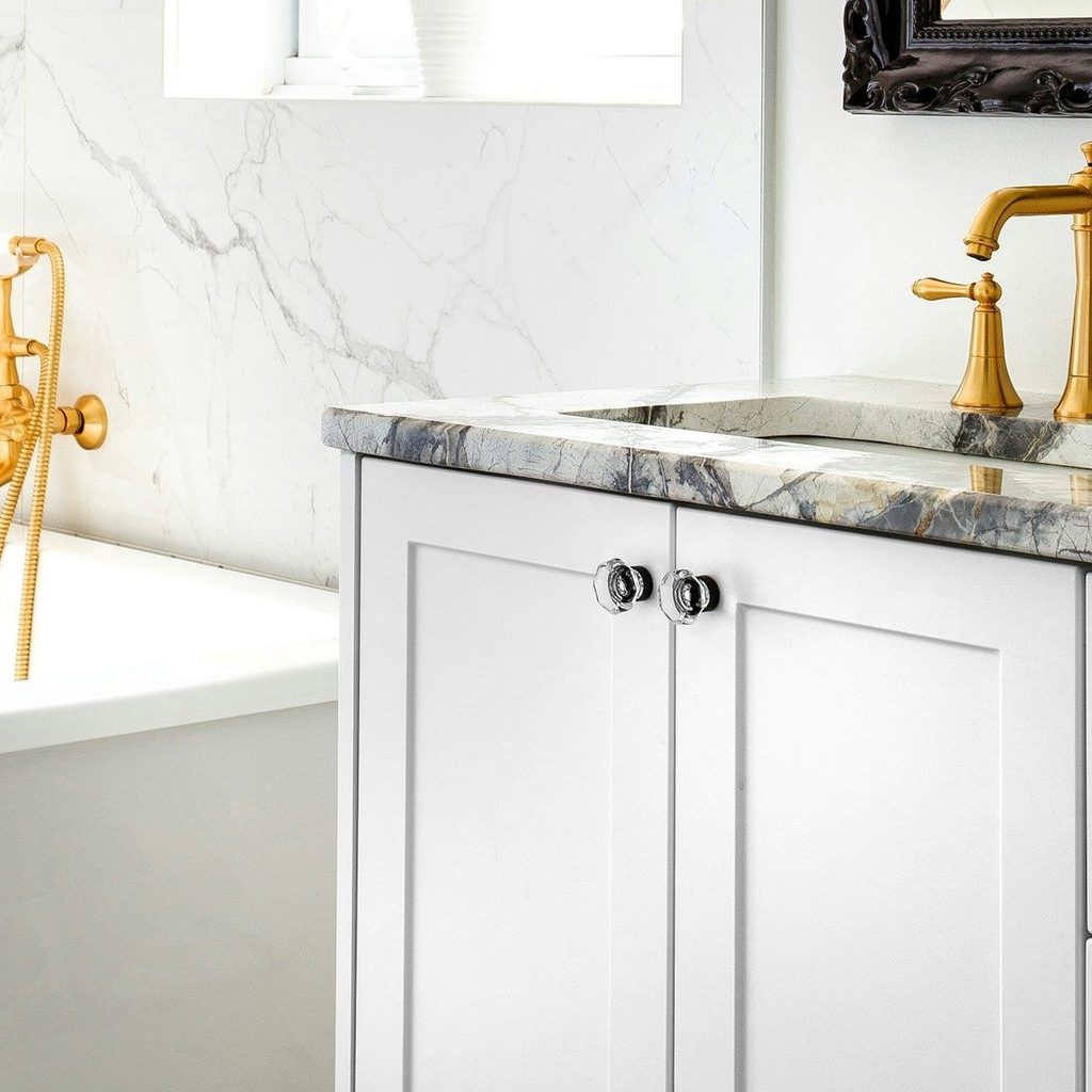 gold bathroom fixtures in black and white bathroom