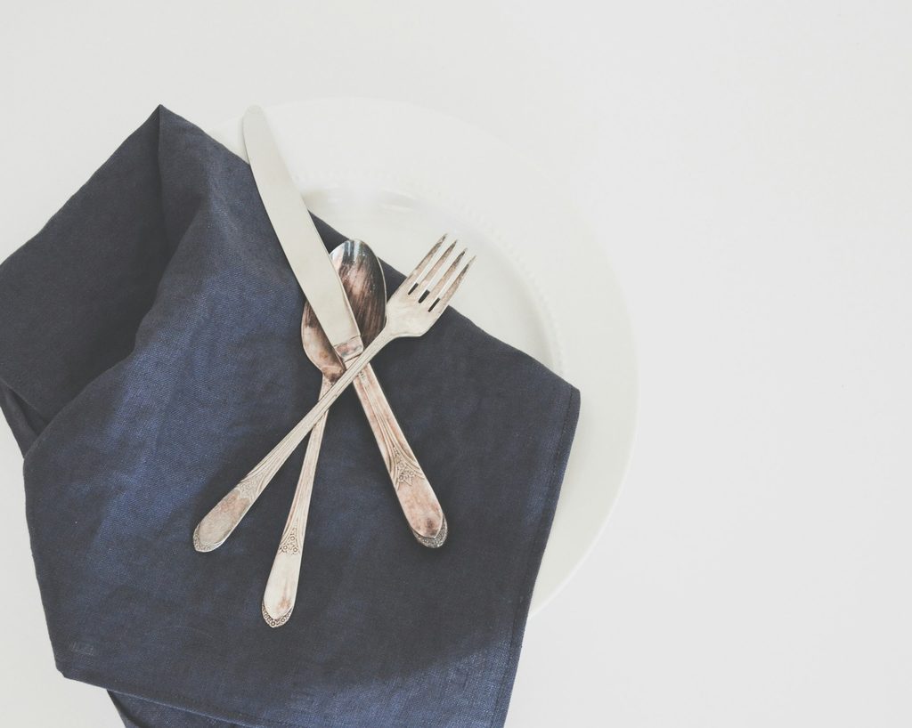 set of silverware on a dark napkin
