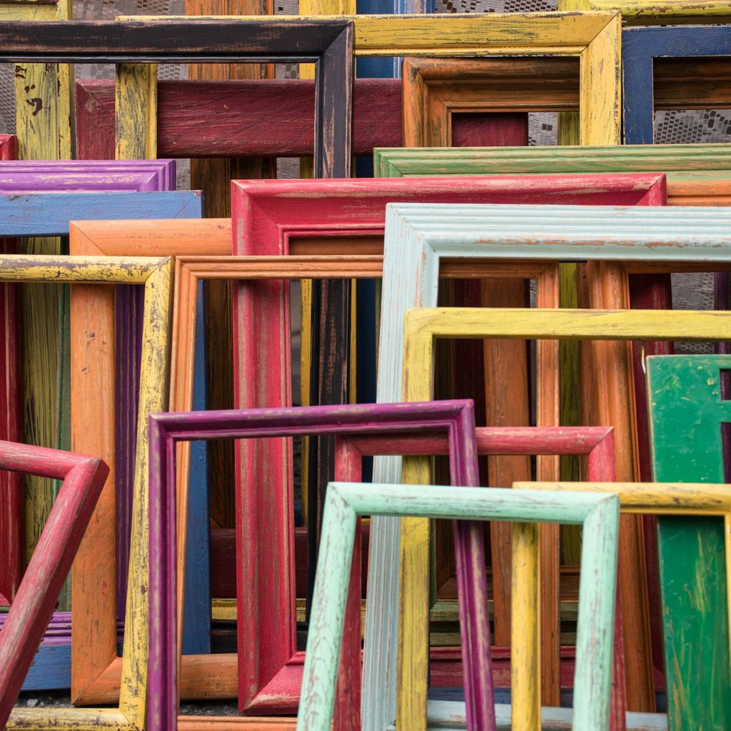 Several old wooden picture frames in varying colors