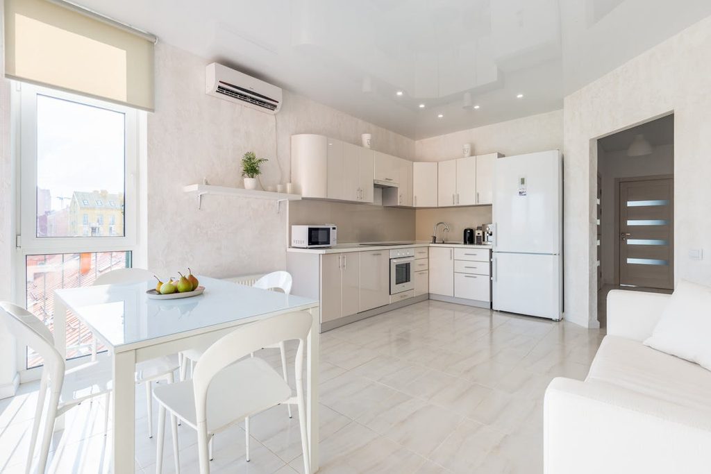 white modern kitchen with roman blinds on window
