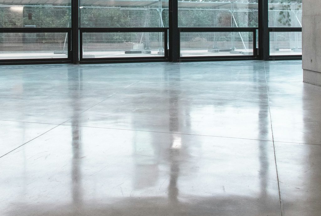 polished concrete floor against large bay windows
